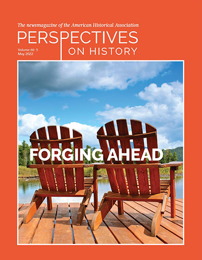 Perspectives on History May 2022 Cover. A orange cover with two orange-brown adirondack chairs sit on a wooden deck facing a lake, green trees and grass cover the opposite shore. The sky is blue and partly cloudy. There is a brown and green lake house and mountains in the distance. 